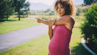 Pregnant woman warming up to jog