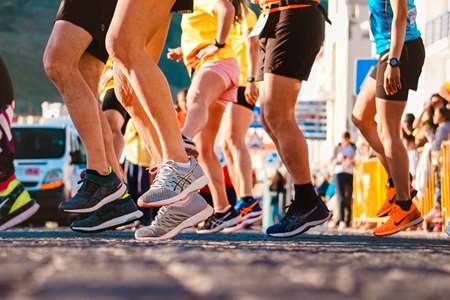 A group of people wearing exercise apparel and participating in a workout activity. 